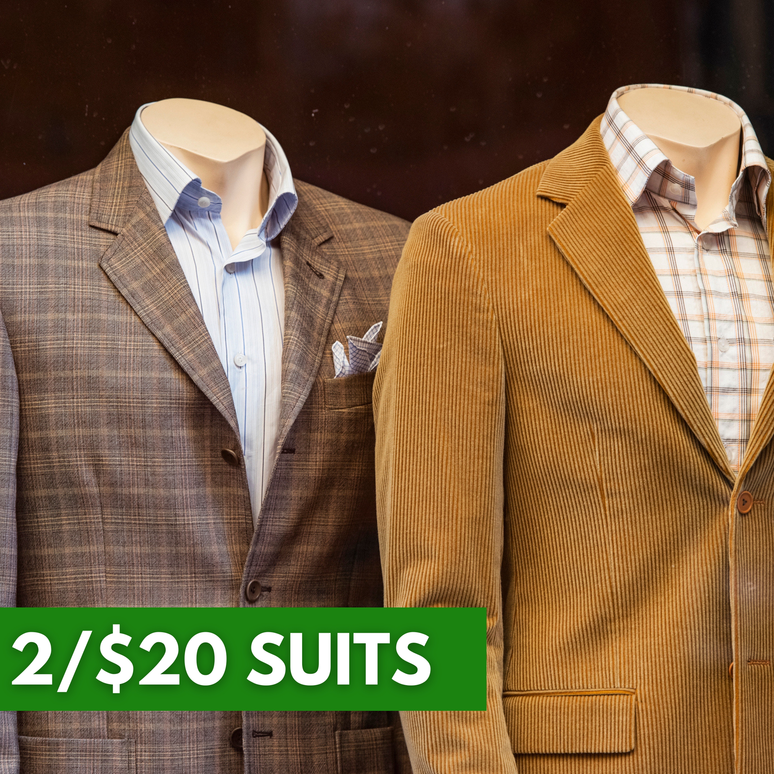 Two black suits with ties are displayed on mannequins. A green label reads 