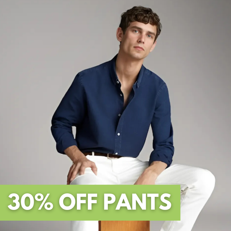 Two black suits with ties are displayed on mannequins. A green label reads 