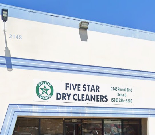 Exterior of Five Star Dry Cleaners with business name, address, and phone number displayed on the building facade.